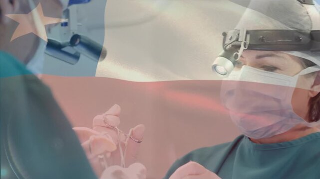 Animation of chile national flag over surgeons wearing headlamp, mask performing surgery in hospital