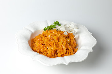 Close-up of braised cabbage with carrots - appetizing vegetable dish