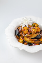 Close-up of salad with fried eggplants - appetizing vegetable dish on white background
