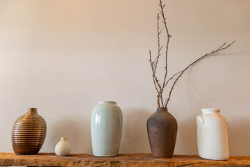 Different ceramic vases on wooden background, The Pottery Gallery.	
