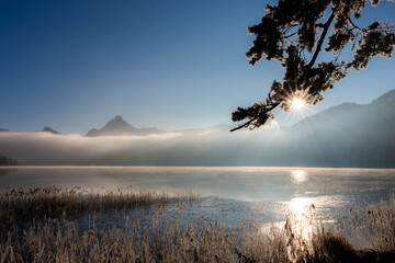 Frosty Sunrise over Weissensee in Bavaria Allgaeu Germany with great sunny Winter Vibes. High...