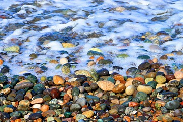 Background, texture of pebble sea beach, sea surf line