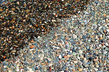 Background, texture of pebble sea beach, sea surf line