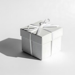 White gift box with ribbon tied around it on white surface