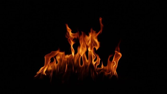 Fire flames burning in the dark night with black background. Abstract flame pattern symbolizing danger, heat, energy, power, passion, and dramatic atmosphere for design and advertising use.