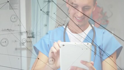 Animation of network of connections and data processing over caucasian male doctor using tablet - Powered by Adobe