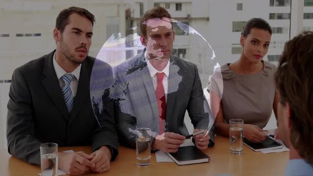 Business team sitting around conference table facing candidate, integrating digital globe overlay