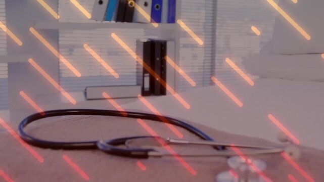 Camera tilting downward over binders revealing coiled stethoscope on desk highlighting medical tool