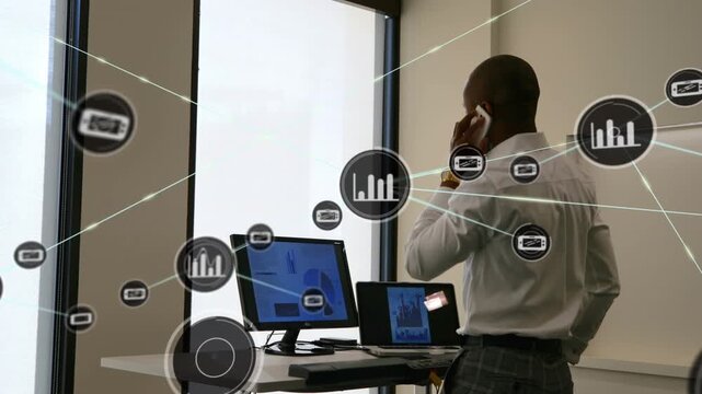 Animation of digital icons over african american man talking on smartphone and walking on treadmill