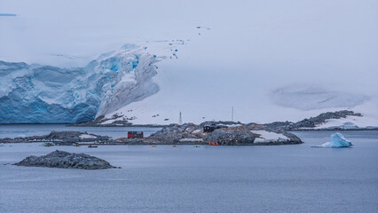 Port Lockroy Antarctica Red Hut Penguin Post Office British Science Station Penguin Colony Natural Habitat. Medium Wide View Over Ocean Snow and Ice