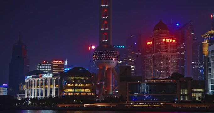 Intriguing Night View of Shanghai with Tower and Glowing Cityscape Lights