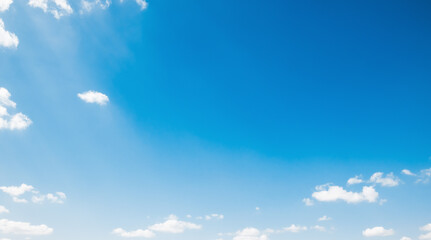 the sky is full of white clouds, bright blue, and beautiful sunlight.