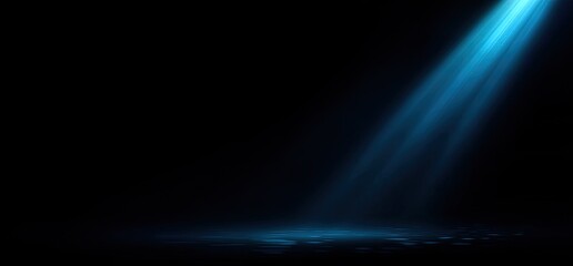 Beam of light shines down, illuminating a dark stage or surface with blue glow