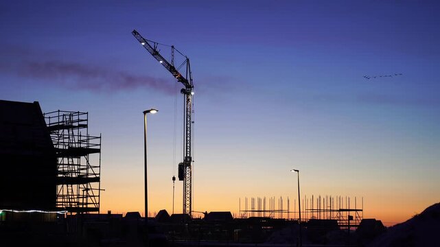 Mijn filmA crane at a construction site during a colourful, winter sunrise. Meerstad, the Netherlands