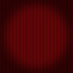 Red velvet stage curtain background with soft folds and lighting