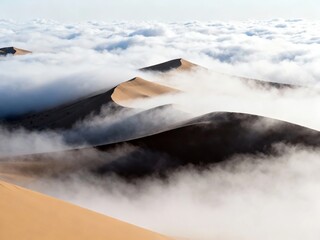 Sand dunes rising above a sea of clouds in a desert landscape