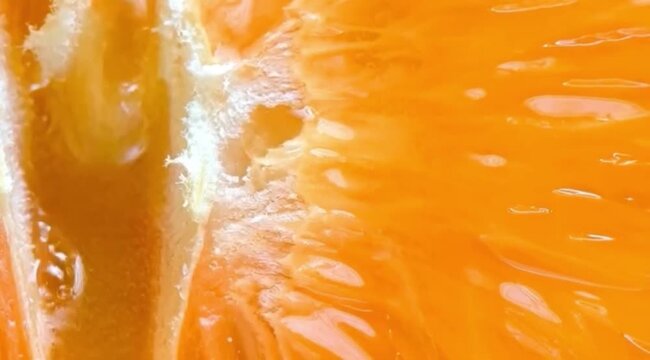 Extreme macro of fresh orange flesh with juicy texture and natural glow, symbolizing vitamin-rich skincare, brightening energy, hydration, and radiant healthy skin inspired by citrus ingredients.