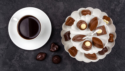 cup of coffee with chocolate pralines