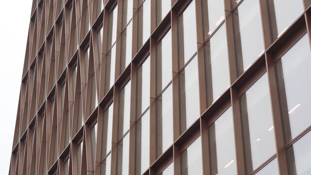 Detailed facade shot highlights architectural rhythm vertical proportions and restrained color palette. Design appears urban minimalist