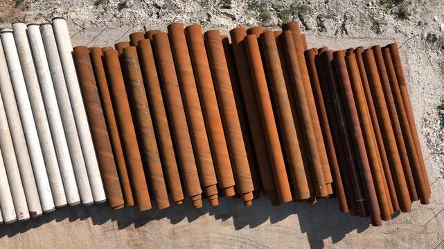 Northern Israel, Israel - January 15 2025: Aerial view of stacked heavy industrial steel pipes
Cinematic drone footage showing a large pile of heavy industrial steel pipes stacked outdoors in an indus