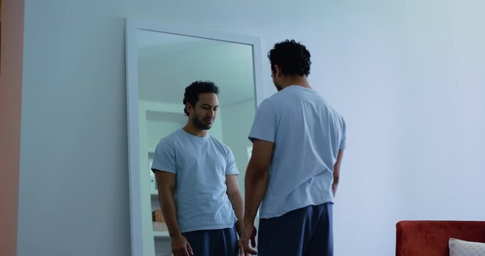 Mirror, mental health and man with disgust in home, disappointment or negative thoughts for shame. Reflection, body dysmorphia or frustrated person with poor self image, tired or upset for appearance