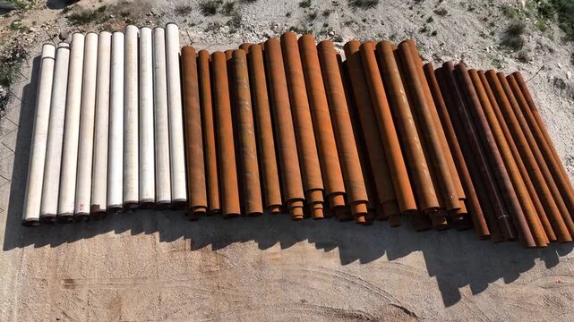 Northern Israel, Israel - January 15 2025: Aerial view of stacked heavy industrial steel pipes
Cinematic drone footage showing a large pile of heavy industrial steel pipes stacked outdoors in an indus