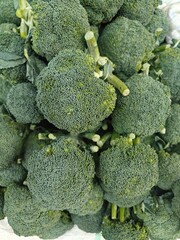 Close up shot of pile of broccoli.