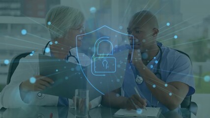 Animation of padlock icon over diverse doctors using tablet in hospital - Powered by Adobe