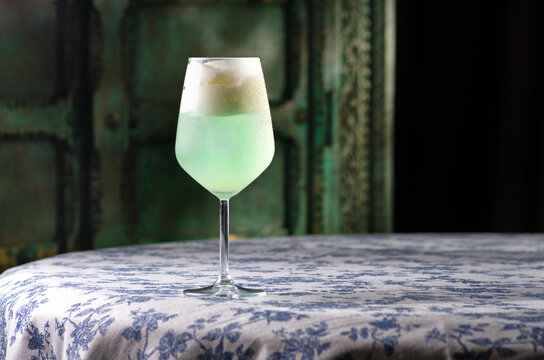 Cocktail with blue drink with lemon on dark background. Space for text