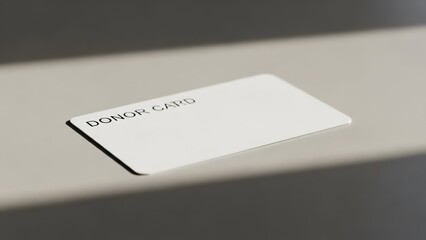 White donor card with "DONOR CARD" text on a light gray surface