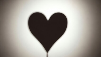 Heart shape shadow on white background