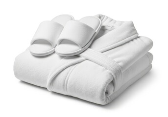 Stack of freshly laundered white terry cloth robe and slippers rests on a clean surface