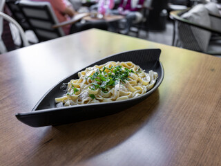 delicious traditional pasta on wooden restaurant table