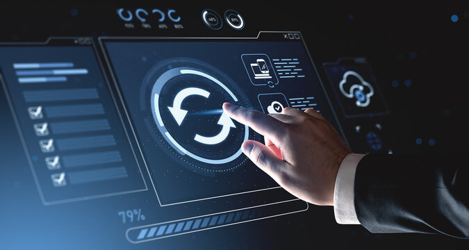 Businessman interacting with futuristic digital interface showing sync and cloud data update concept on high-tech background. - Powered by Adobe