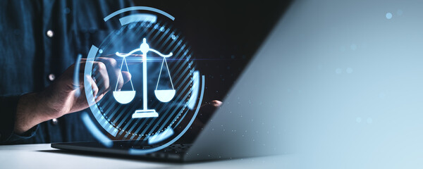 Digital justice concept with person interacting on laptop and virtual law scale icon on a futuristic blue background with tech elements and creative lighting.