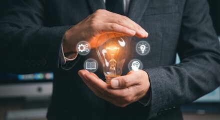 Professional Adult White Man in Business Suit Holding Glowing Lightbulb with Digital Innovation and Education Icons for Creative Concept in Dark Office
