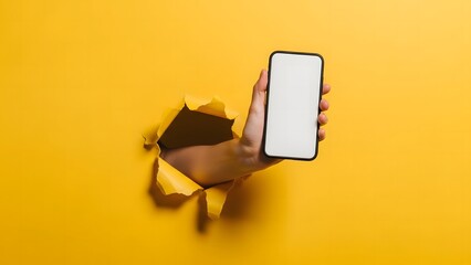 Blurry image of a hand holding a smartphone against a yellow background