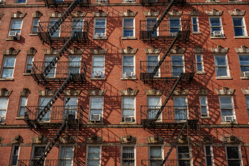 Chinatown neighborhood of Manhattan, New York City. The Fire Escapes: The black iron zig-zagging stairs on the exterior are one of the most recognizable features of New York architecture.