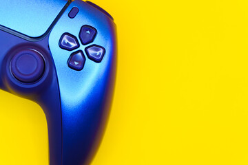 A gamepad for consoles on a yellow background, gaming addiction, gaming ban for teenagers, gaming controls for parents, for banners and advertising. High quality © Karen Vardanian