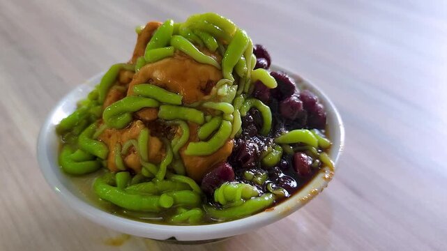 Cendol is a Malaysian dessert made of shaved ice, coconut milk, green pandan jelly noodles, and sweet dark brown sugar syrup (Melaka Sugar). Optional toppings include red beans or sweet corn for extra