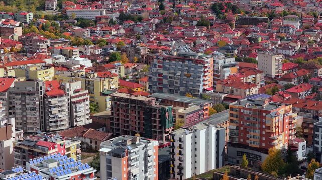 Aerial video of Kor&ccedil;&euml; in southeast Albania showing dense neighbourhoods and  colourful rooftops. 