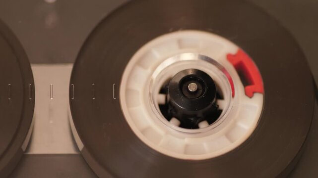Macro close-up vintage audio cassette spinning in old tape player retro analog music nostalgia 80s 90s