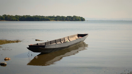 Fishing boat on the lake in the morning. Landscape.