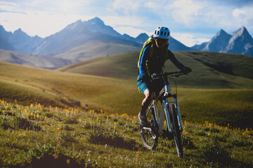 Fototapeta premium Mountain bike on flowering grassland mountains