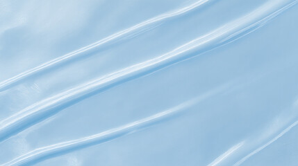 Obraz premium 淡い水色の光沢布が優雅に波打つシルク調の上品なテクスチャ背景