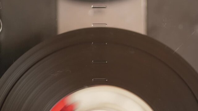  Close-up of vintage audio cassette rewinding tape inside cassette deck