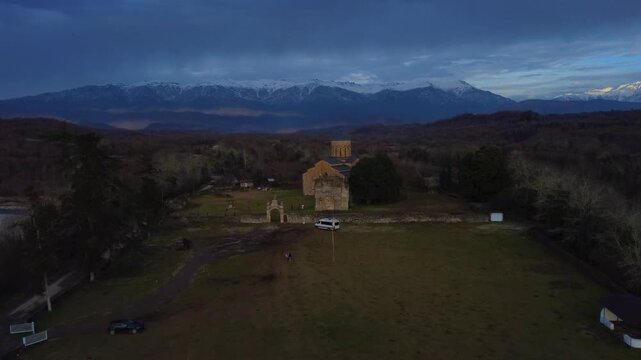 MOKVA, Abkhazia - 4.01.2025: Mokva Cathedral of the Assumption of the Blessed Virgin Mary, aerial view. Christianity. Holy sites. Ancient church built in the 10th century. Christian shrine. Dron. 4К
