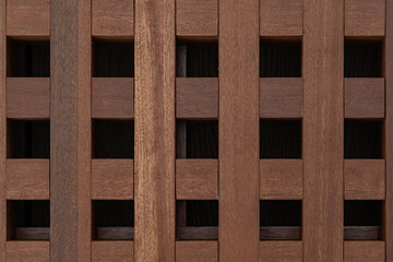 Brown wooden lattice grid texture. Square geometric pattern wood background design close-up.