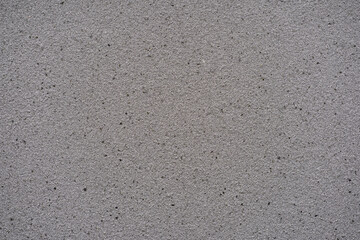 Gray asphalt road texture background. Rough grainy bitumen surface seamless pattern top view.