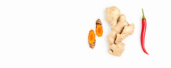 Ginger, turmeric and chili isolated on white background. Minimalist spicy immunity booster composition with natural root and pepper ingredients for wellness, health and nutrition concepts